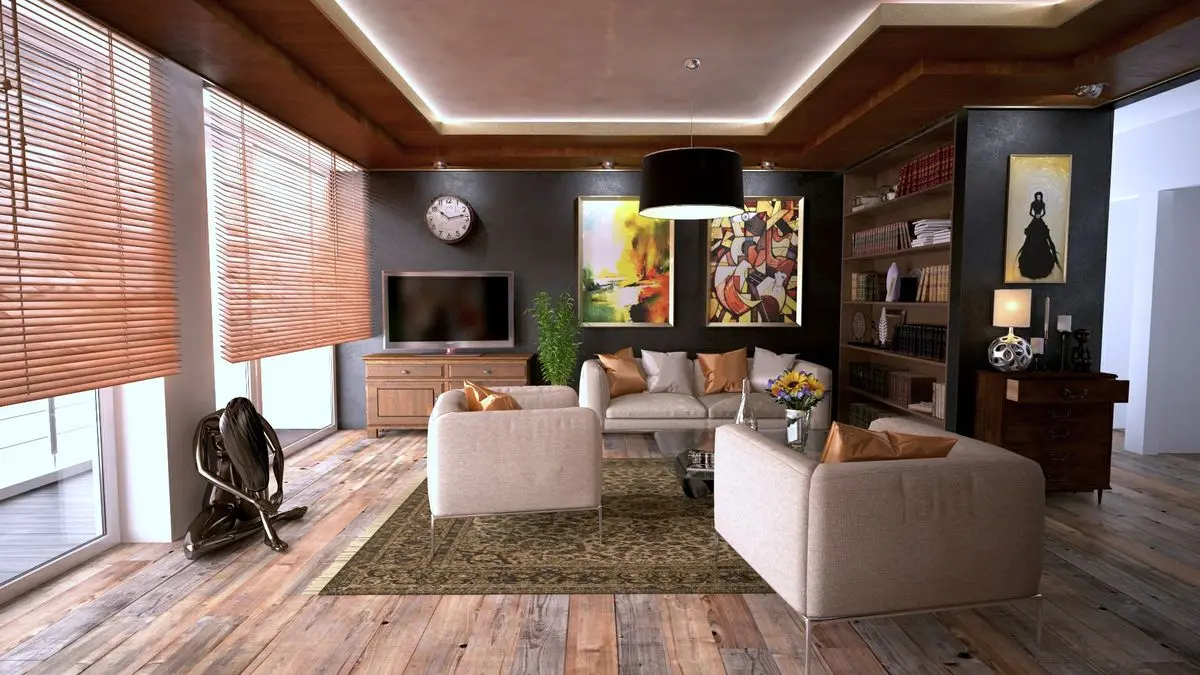 A living room with a wood bookcase, a dresser, and two light armchairs